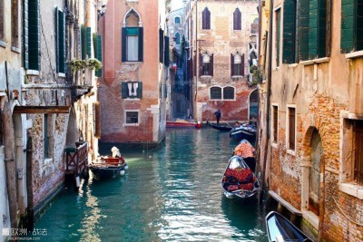 12734262-beautiful-colorful-canal-in-venice-with-parked-gondolas-near-traditiona.jpg